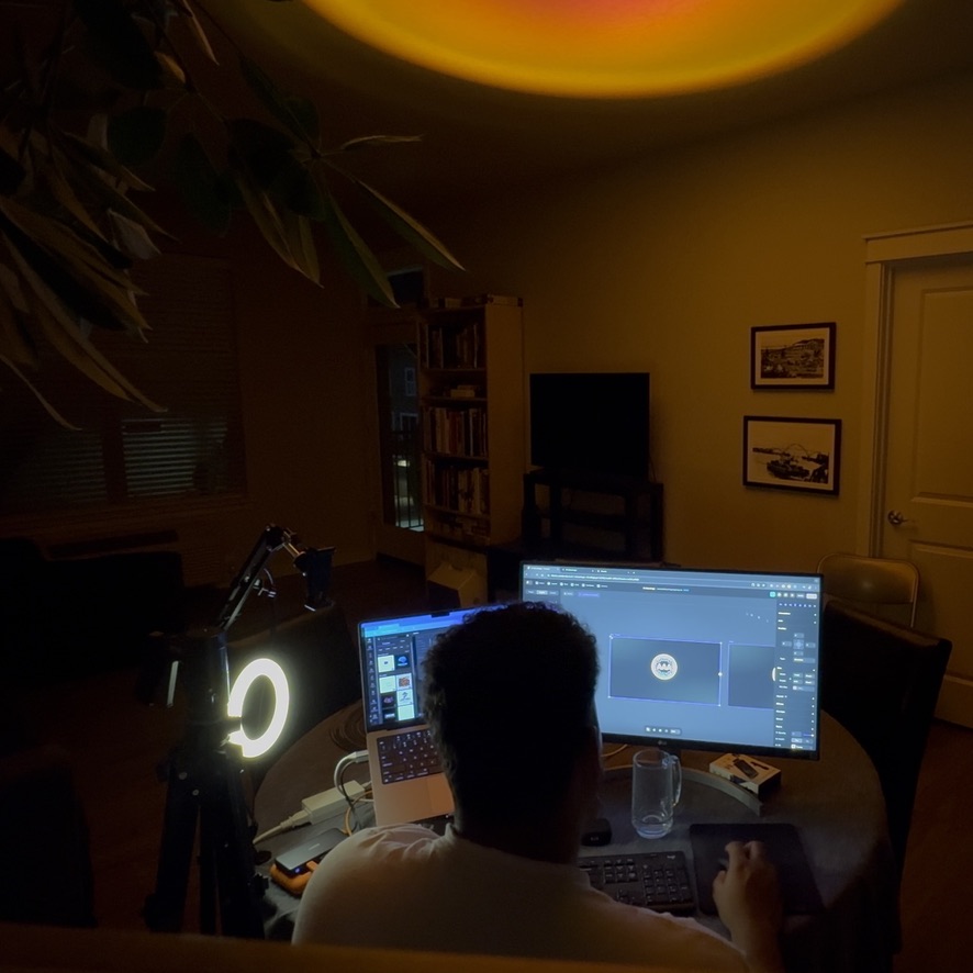 Shawn working at a multi-screen setup after dark