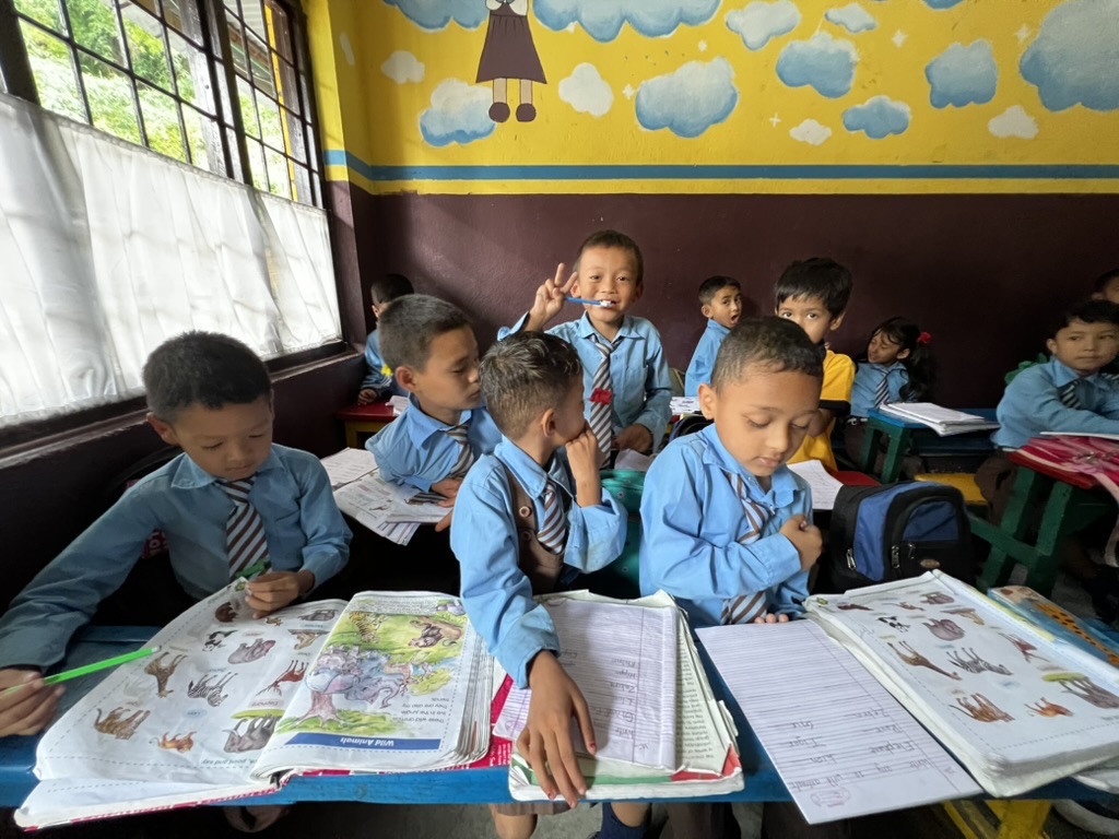 Students working at their desks in the Nepal classroom