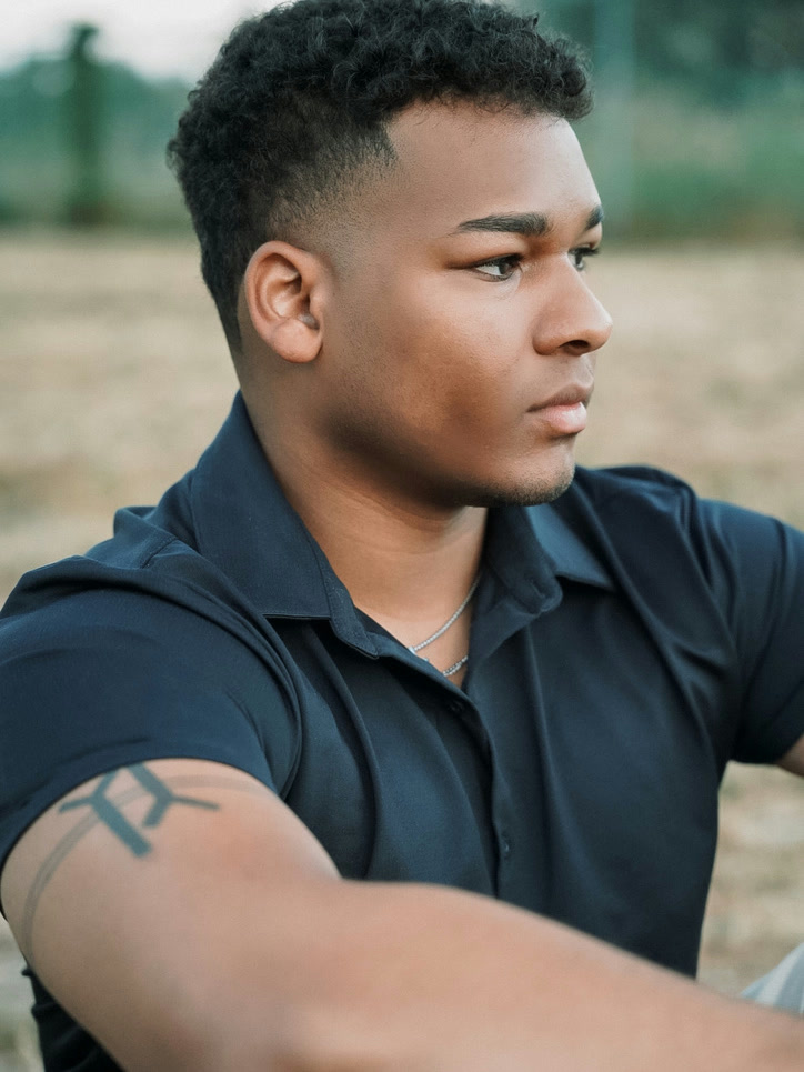 Shawn seated outdoors in profile